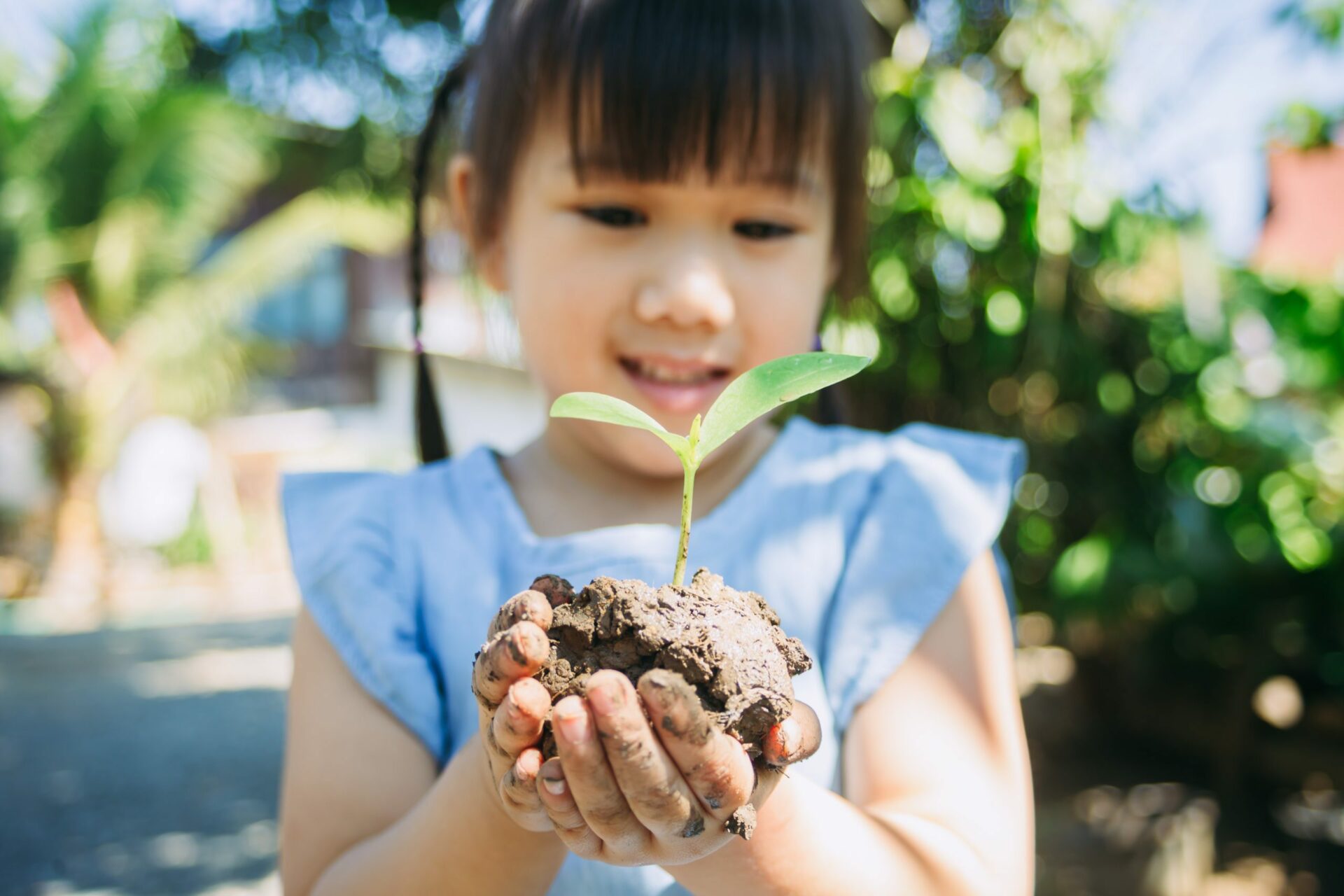 Cute kid planting a tree for help to prevent global warming or climate change and save the earth. Picture for concept of Earth Day to encourage people about the environmental protection.